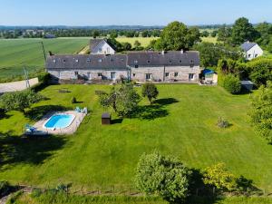 an aerial view of an old stone house with a large yard at La Maison Neuve Gîtes in Madré