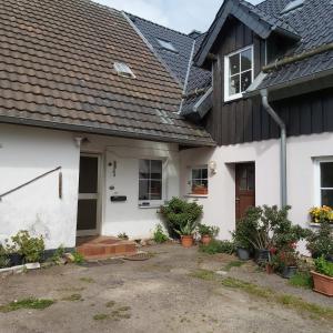 a white house with a black roof at Eifelhaus in Niederdorla
