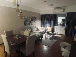 a living room with a couch and a table at Grand Cenia Condominium Cebu in Cebu City