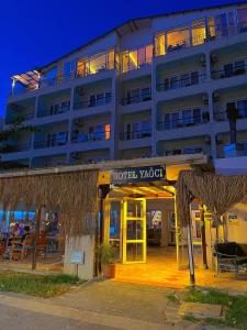 a hotel with a hotel yoda sign in front of it at Yağcı Hotel Erdek in Erdek +53 photos