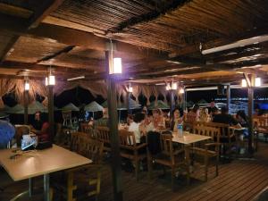 a group of people sitting at tables in a restaurant at Yağcı Hotel Erdek in Erdek