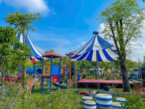 a playground with a blue and white tent at Mekong Camping Deluxe in Ấp Thanh Sơn (1)