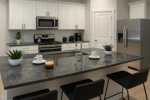 a kitchen with white cabinets and a counter with a sink at Quiet Haven in Richmond