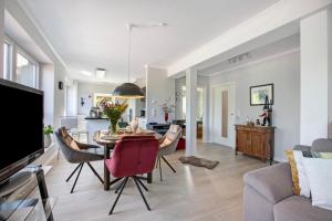 a dining room and living room with a table and chairs at Ferienwohnung Alte Tischlerei in Hemmingstedt