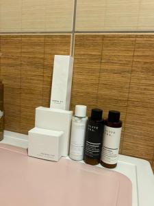 four bottles ofodorizers sitting on a counter in a bathroom at Apartment City kvart in Podgorica