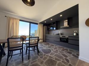 a kitchen with a dining room table and chairs at V.V. Verde Amanecer 2 in Las Casas