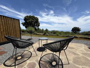 two chairs and a table on a patio at V.V. Verde Amanecer 3 in Las Casas