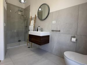 a bathroom with a sink and a shower and a mirror at V.V. Verde Amanecer 5 in Las Casas