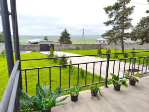 a balcony with plants and a fence at Bluebell Cottage in Tsalka