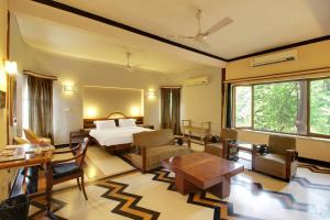 a hotel room with a bed and a table and chairs at Hotel Inn Season - Art Deco Heritage Hotel in Jodhpur in Jodhpur +46 photos