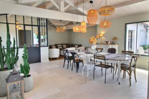 a dining room with a table and chairs at MIA in La Noue +8 photos