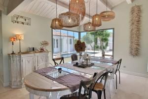 a dining room with a wooden table and chairs at MIA in La Noue