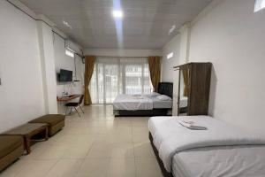 Postel nebo postele na pokoji v ubytování Agave Hotel Siantar