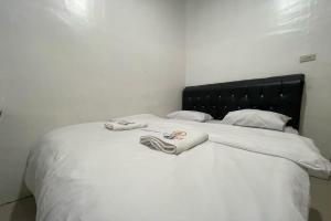 Postel nebo postele na pokoji v ubytování Agave Hotel Siantar