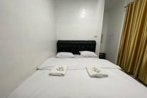 Postel nebo postele na pokoji v ubytování Agave Hotel Siantar