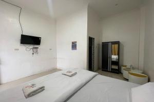 Postel nebo postele na pokoji v ubytování Agave Hotel Siantar