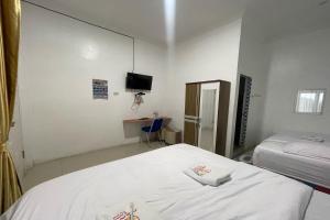 Postel nebo postele na pokoji v ubytování Agave Hotel Siantar