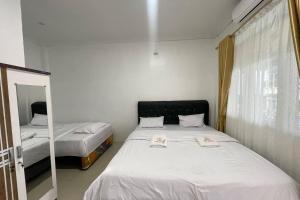 Postel nebo postele na pokoji v ubytování Agave Hotel Siantar