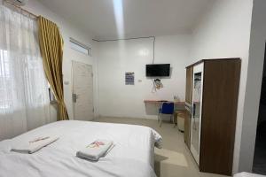 Postel nebo postele na pokoji v ubytování Agave Hotel Siantar