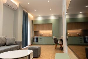 a living room with a couch and a table at Regal Luxury Apartments in Sarandë