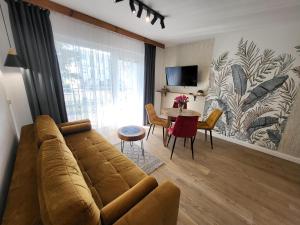 a living room with a couch and a table at Zatoka Apartamenty in Władysławowo