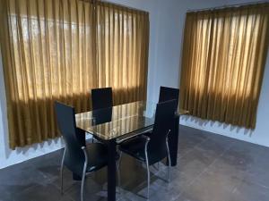 a dining room with a glass table and chairs at Kubu Jimbaran in Jimbaran