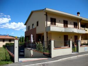 a large house with a fence in front of it at Casa Vacanze Alle Porte del Chianti in San Giovanni Valdarno