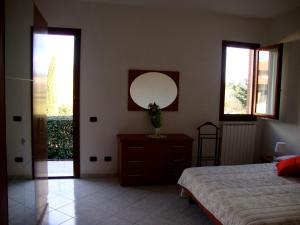 A bed or beds in a room at Casa Vacanze Alle Porte del Chianti