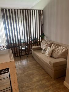a living room with a couch and a balcony at Relax Guemes in Mar del Plata