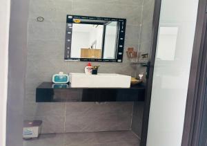a bathroom with a white sink and a mirror at Sunrise Homestay with 4 Bedrooms in Da Nang +13 photos