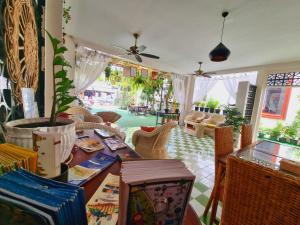 a room with a table and chairs and a living room at Maison Saiko Angkor Boutique in Siem Reap