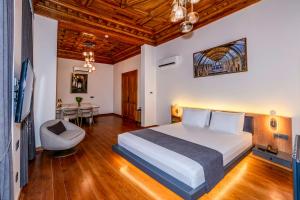 a bedroom with a bed and a chair in a room at Elmira Pera Hotel & - Special Class in Istanbul