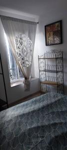 a bedroom with a bed and a window at Au coeur du Gard in Saint-Bauzély