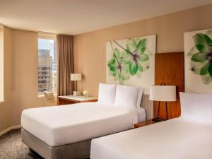 a hotel room with two beds and a window at Fairmont Chicago Millennium Park in Chicago