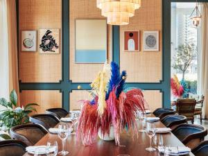 a table in a restaurant with a peacock centerpiece at 25hours Hotel Dubai One Central in Dubai