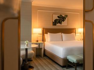 a hotel room with a bed and a chair at Fairmont Chicago Millennium Park in Chicago