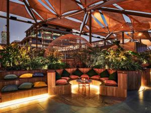 a patio with a couch and a table with plants at 25hours Hotel Dubai One Central in Dubai