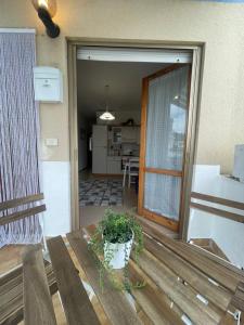 a porch with a bench and a potted plant at Casa del Moro in Marina di San Vito