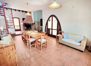 a living room with a table and chairs and a fireplace at Villa Rosa Bestvacationever in Torre delle Stelle
