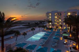 a view of a resort with a swimming pool and the beach at Treasure Island Beach Resort in St Pete Beach