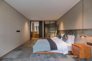 Giường trong phòng chung tại Shanyu Life Huangshan Design Hotel