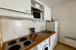 a small kitchen with a sink and a microwave at Les Naïades I45 - 2 bedrooms for 5 people ! in Avène +10 photos