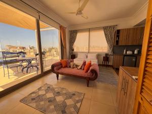 a living room with a couch and a balcony at Villa D60 in Sharm El Sheikh