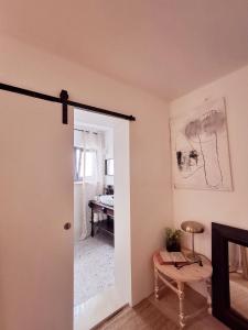 a room with an open door with a chair and a table at CasaCalla in Okrug Donji