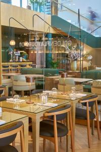 a restaurant with tables and chairs in a room at Golden Residence Hotel in Funchal