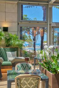 a patio with tables and chairs in a restaurant at Golden Residence Hotel in Funchal