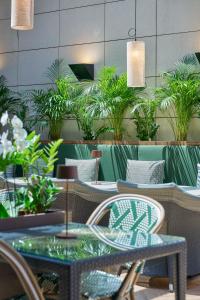 a restaurant with tables and chairs and potted plants at Golden Residence Hotel in Funchal