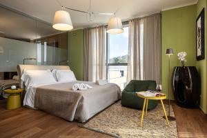 a bedroom with a large bed and a green wall at Sardegna é - BApartments in Olbia
