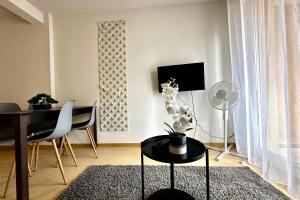a living room with a desk and a table and chairs at Les Naïades I45 - 2 bedrooms for 5 people ! in Avène