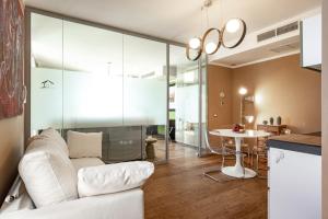 a living room with a white couch and a table at Sardegna é - BApartments in Olbia